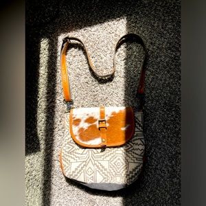 Beautiful Myra bag with a cow hide flap and Aztec canvas front.